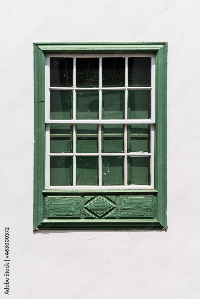 Traditional green painted window in canarian colonial style house in the old town of Santa Cruz de La Palma, in the quarter of San Sebastian, also known as La Canela