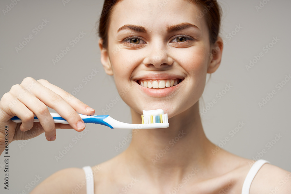 cheerful woman toothpaste brushing teeth dental health light background cheerful woman toothpaste brushing teeth dental health light background