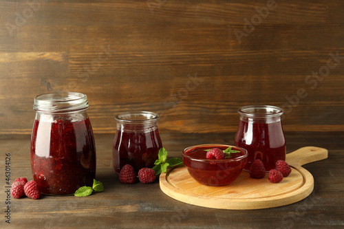 Concept of tasty food with raspberry jam on wooden background