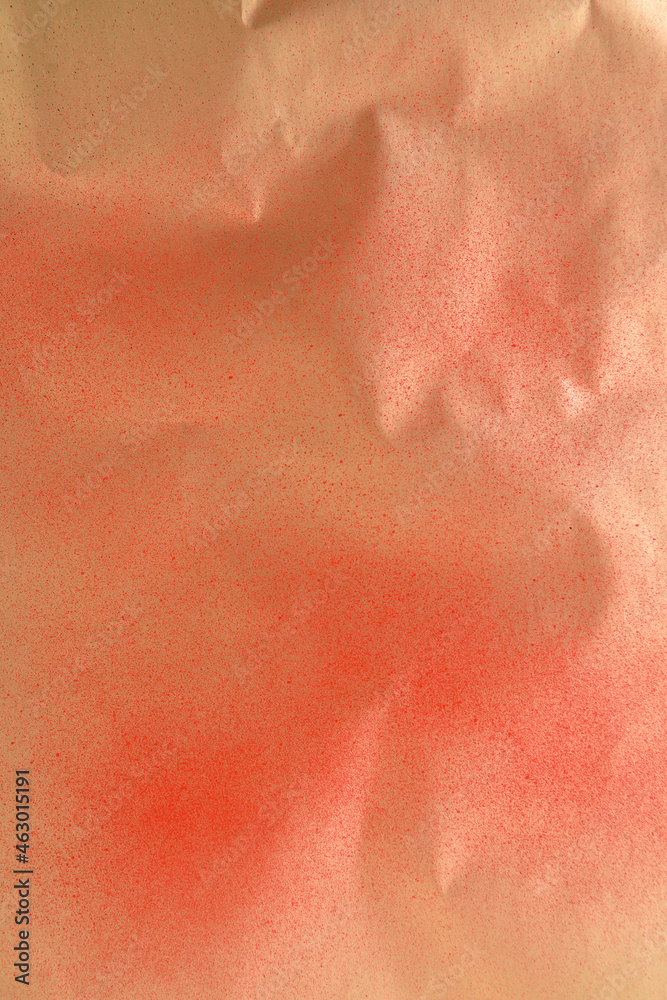 Fototapeta premium red spray paint on gold colored paper