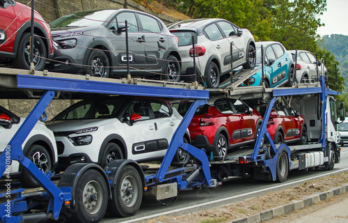 Car carrier. Cars transported on the car platform. New cars. No logo or brand.