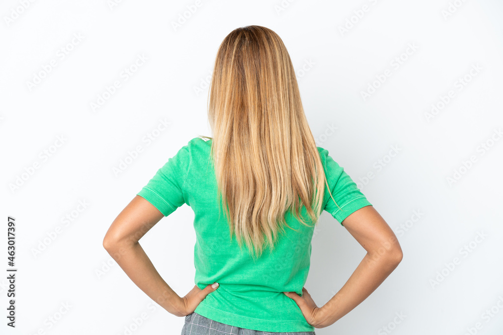 Blonde Uruguayan girl isolated on white background in back position Blonde Uruguayan girl isolated on white background in back position
