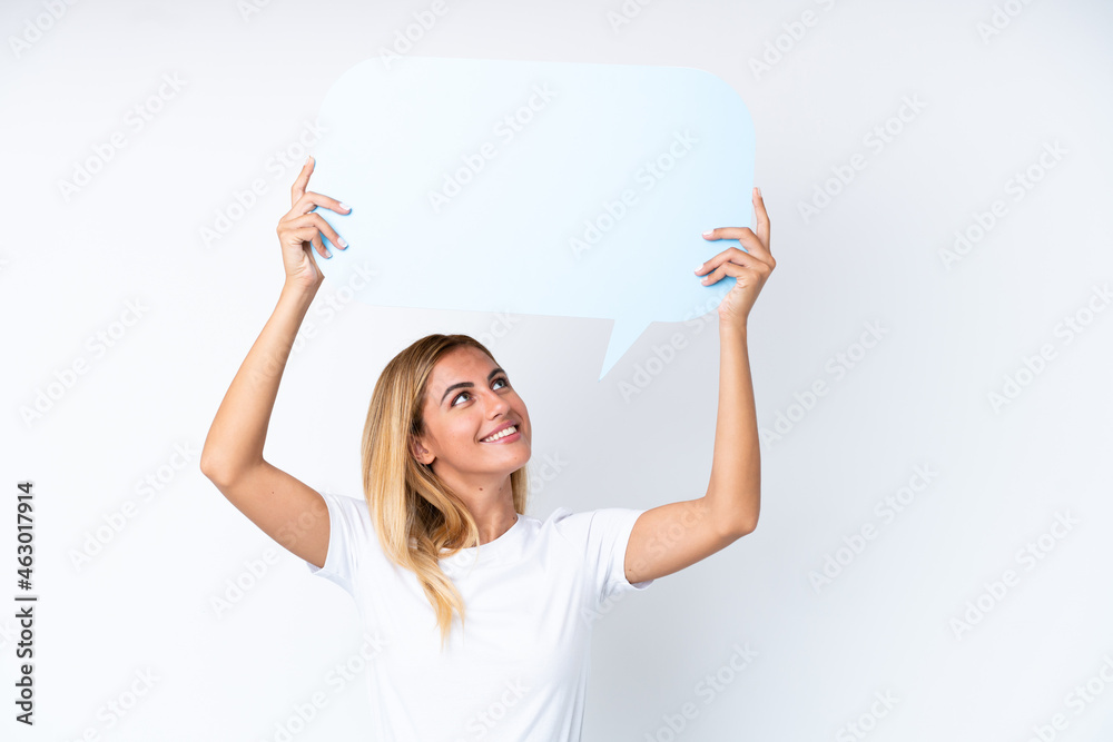 Blonde Uruguayan girl isolated on white background holding an empty speech bubble Blonde Uruguayan girl isolated on white background holding an empty speech bubble