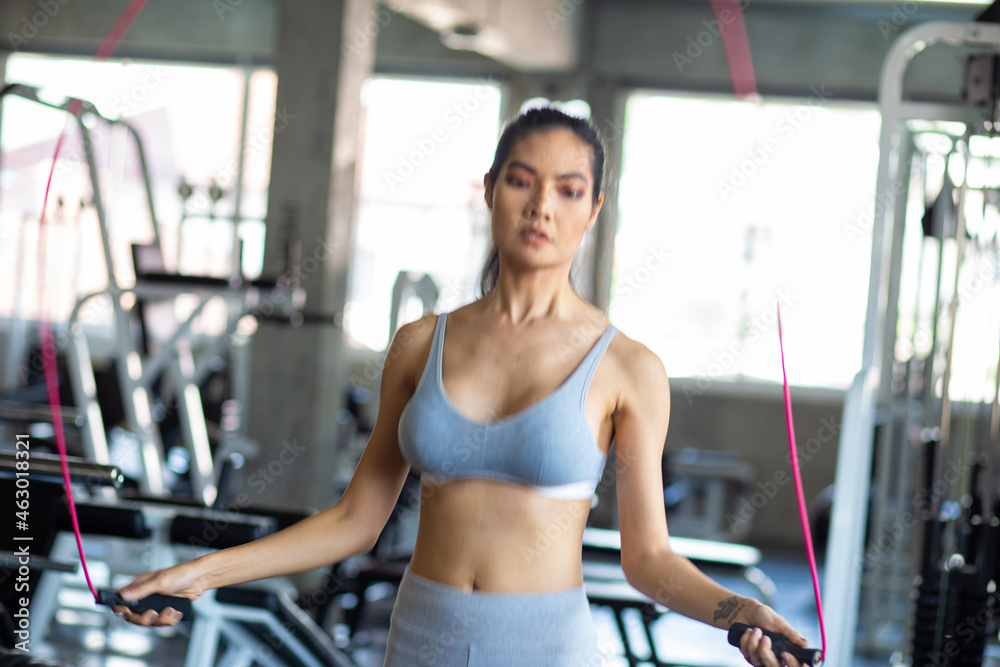 Sport women jumping rope trainning in gym Sport women jumping rope trainning in gym