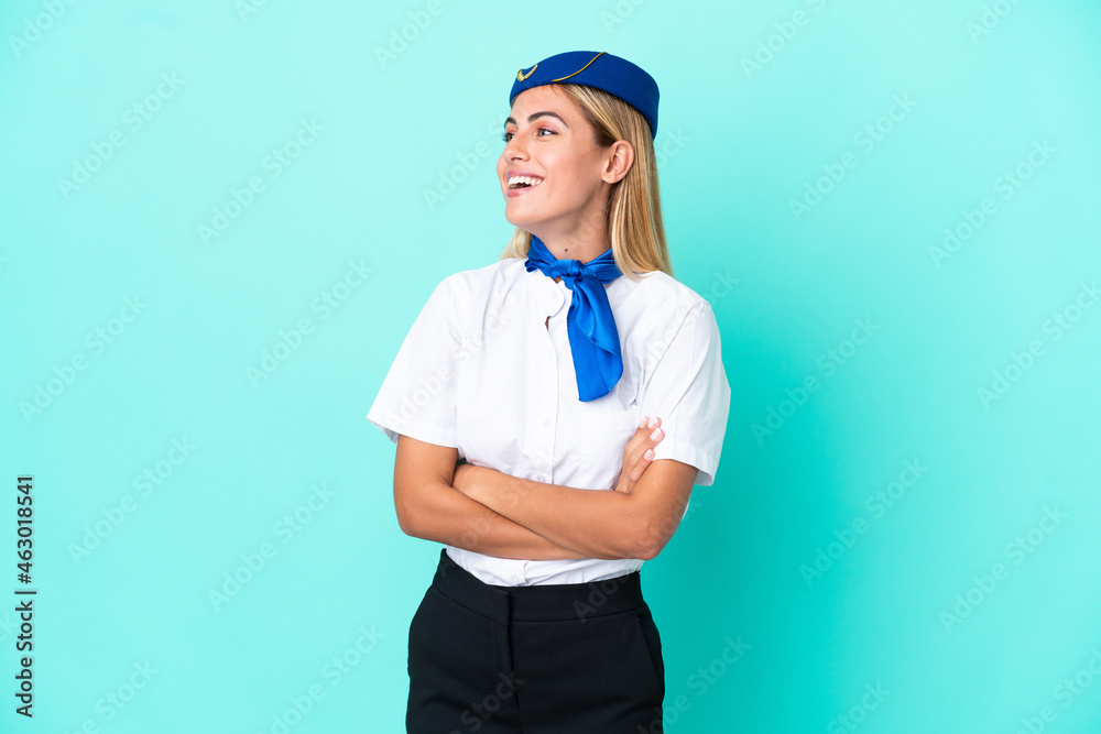 Airplane stewardess Uruguayan woman isolated on blue background happy and smiling Airplane stewardess Uruguayan woman isolated on blue background happy and smiling