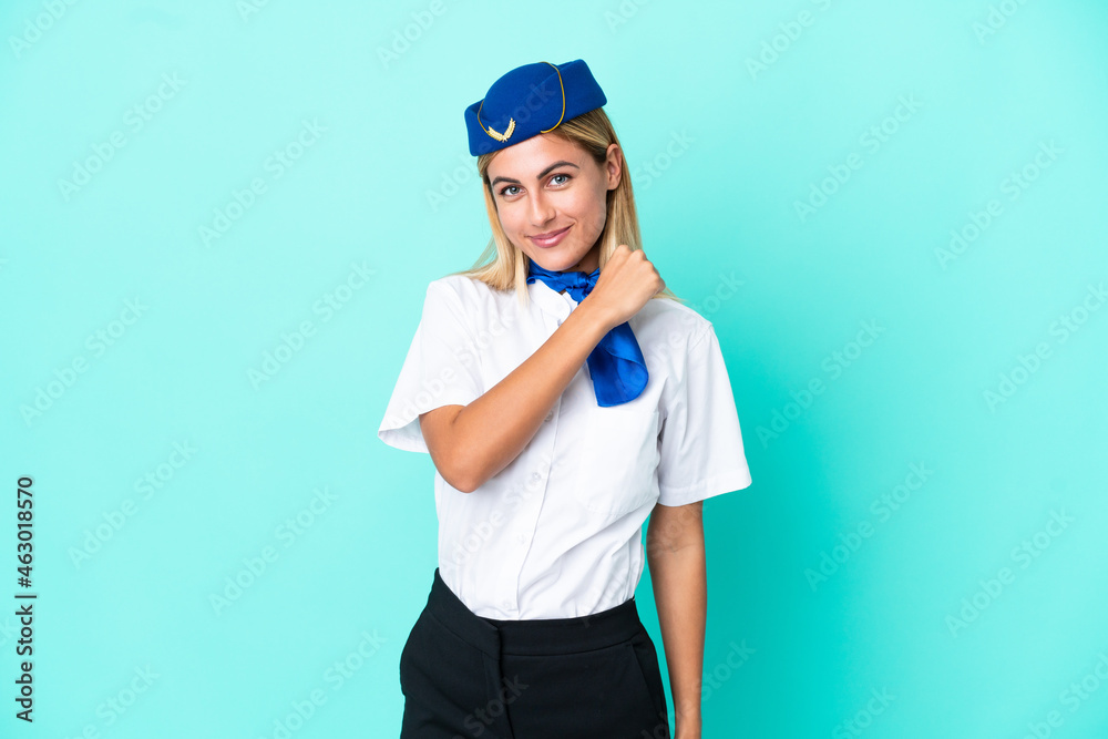 Airplane stewardess Uruguayan woman isolated on blue background celebrating a victory