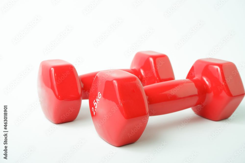 Sport equipment. Two red dumbbells for fitness weighing 2 kg on a white background. Sport equipment. Two red dumbbells for fitness weighing 2 kg on a white background.