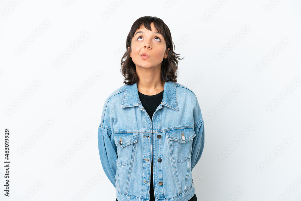 Young mixed race woman isolated on white background and looking up