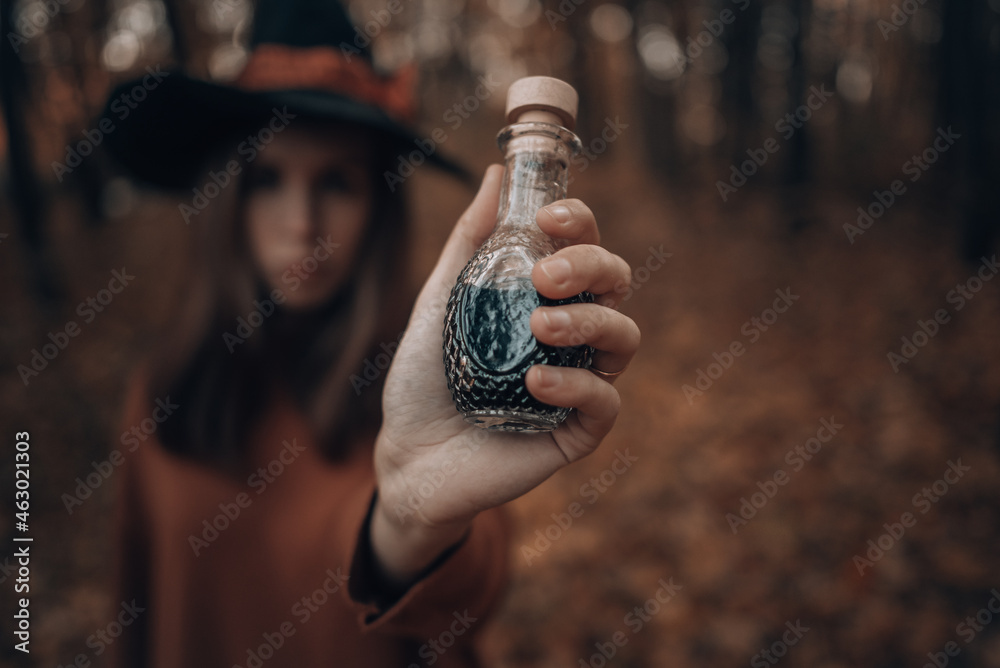 love drink: witch's potion in a glass bottle in hand
