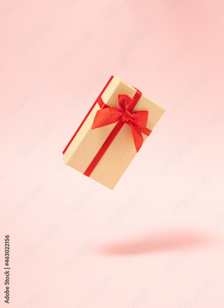 modern abstract christmas gift box in the air against pastel pink background. futurisam. minimalism. modern creative decoration idea. modern abstract christmas gift box in the air against pastel pink background. futurisam. minimalism. modern creative decoration idea.