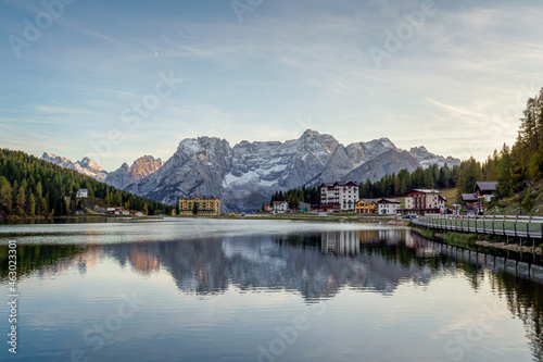Sunset over Misurina Lake with sky reflection in calm water. View on the majestic Dolomites Alp Mountains, National Park Tre Cime di Lavaredo, Dolomiti Alps, South Tyrol, Italy