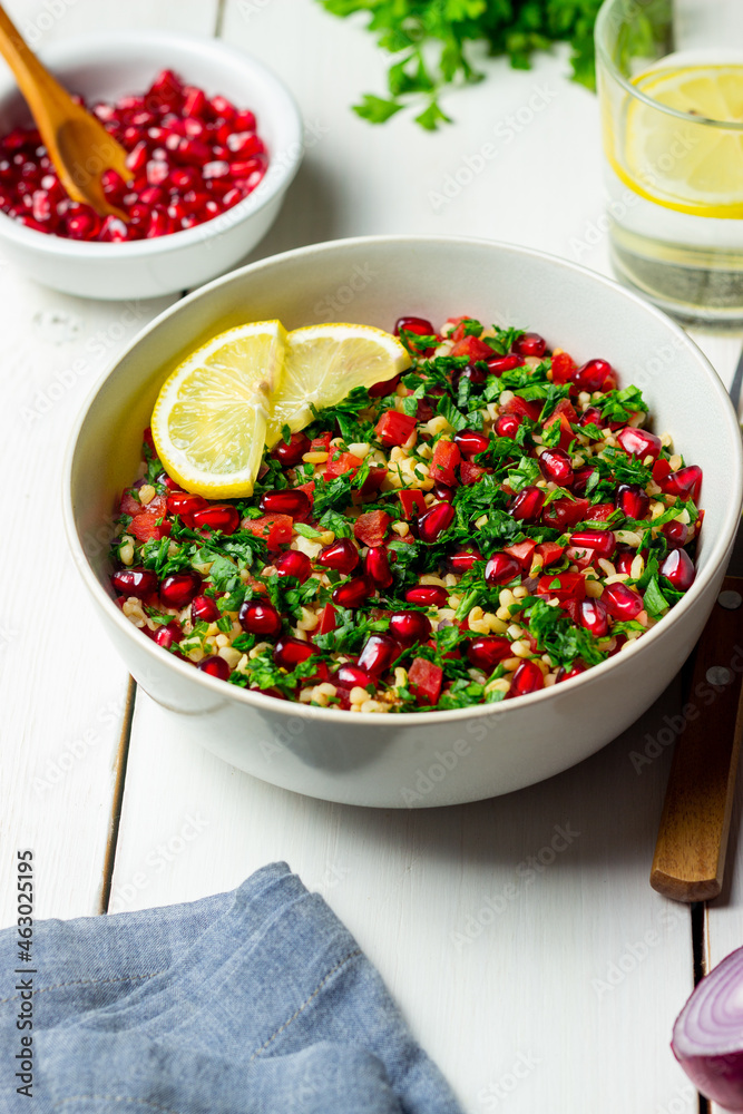 Tabbouleh salad with bulgur, mint, parsley, tomatoes and pomegranate. Healthy eating. Vegetarian food. Tabbouleh salad with bulgur, mint, parsley, tomatoes and pomegranate. Healthy eating. Vegetarian food.