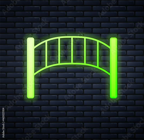 Glowing neon Playground kids bridge icon isolated on brick wall background. Vector