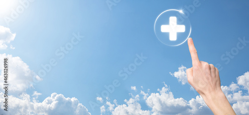 Businessman hold virtual plus medical network connection icons. Covid-19 pandemic develop people awareness and spread attention on their healthcare.
