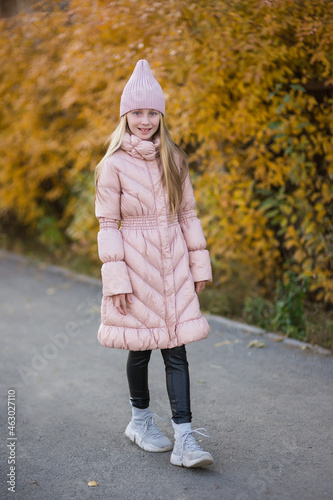 Portrait of beautiful girl on the street. autumn coat in the city. © viclin