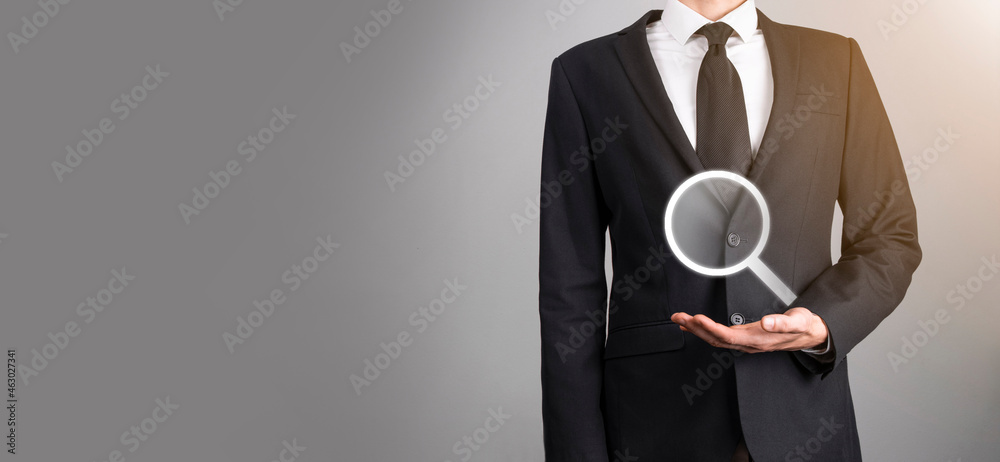 Male hand holding magnifying glass ,search icon on blue background. Concept search engine optimization, customer support.Browsing Internet Data Information.Networking Concept. Male hand holding magnifying glass ,search icon on blue background. Concept search engine optimization, customer support.Browsing Internet Data Information.Networking Concept.