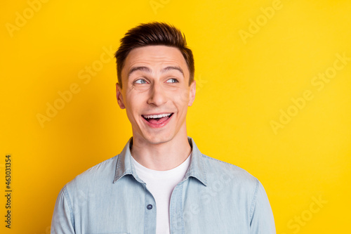 Photo of young cheerful good mood handsome guy look copyspace big sale discount black friday isolated on yellow color background © deagreez