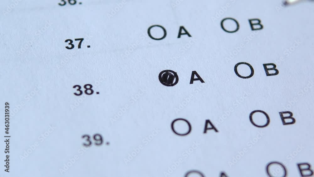 Close up view, student taking exams, filling out standardized test form with answers, answer to the questions, education, examination concept. Close up view, student taking exams, filling out standardized test form with answers, answer to the questions, education, examination concept.