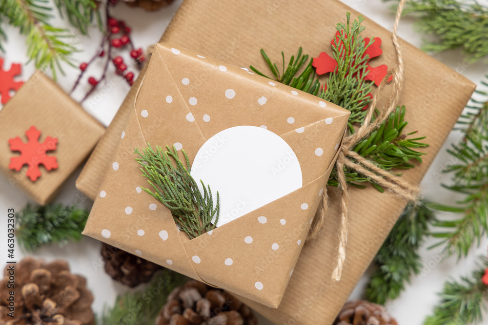 Christmas present with round blank gift tag and decorations, Mockup
