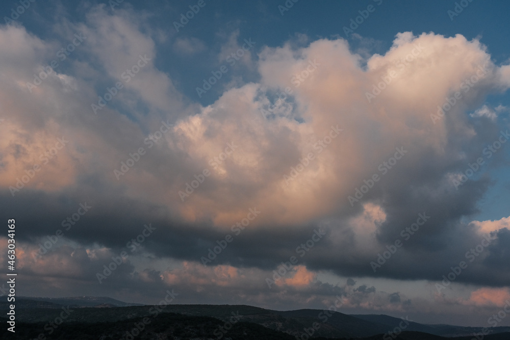 Sunset colored clouds above Western Galilee Mountains as seen from Eagles Cliff Park in Mi'ilya village, Upper Galilee, Northern District of Israel, Israel Sunset colored clouds above Western Galilee Mountains as seen from Eagles Cliff Park in Mi'ilya village, Upper Galilee, Northern District of Israel, Israel