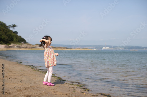 young girl playing at summer sand beach