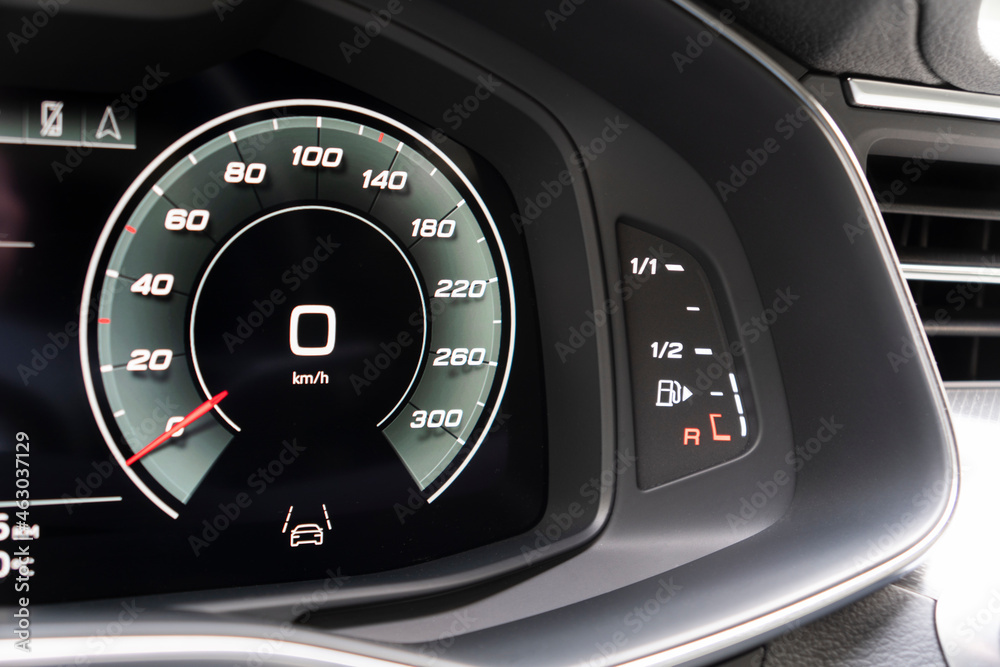 Close up shot of a digital speedometer in car. Fully digital car dashboard. Dashboard details with indication lamps. Car instrument panel.