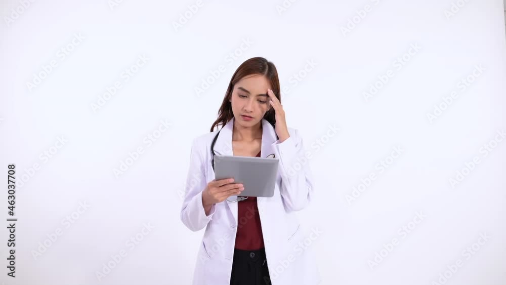 female doctor in long hair confuse while using tablet female doctor in long hair confuse while using tablet