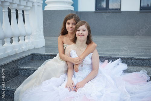 Girl with Down syndrome and little girl.