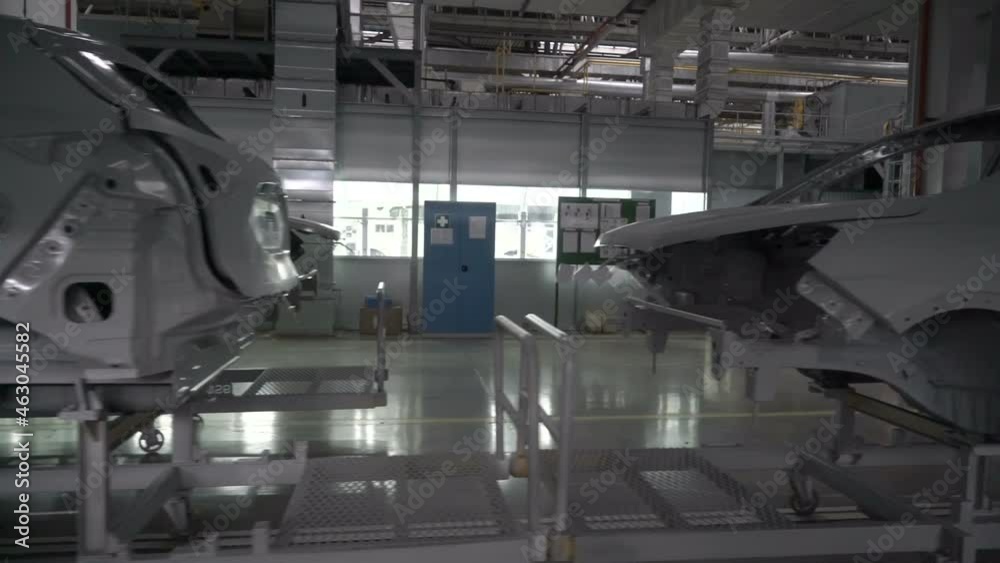 Car bodies before painting. Car manufacturing factory.
