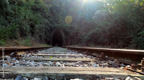 Ancient steam train comes out of the tunnel, shot from below.