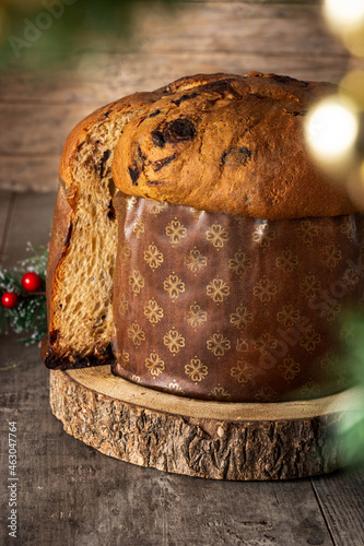 Traditional Italian panettone for Christmas on rustic wooden table.