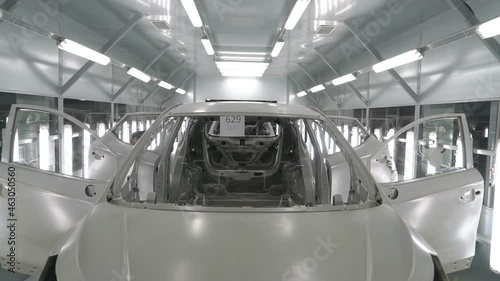 Checkman are checking assembling of car bodies before painting process. Car manufacturing factory.