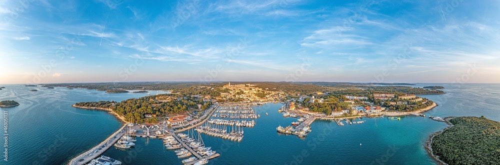 Drone panorama over the harbor of Croatian coastal town Vrsar in Istria during sunset