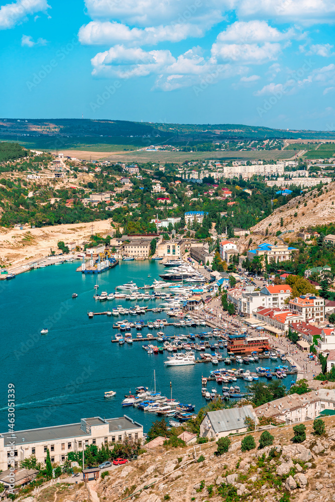 A picturesque panorama of the Balaclava view with yachts and a colorful bay in summer. Postcard view of the tourist Crimea.