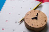 close up of calendar and clock on the blue table background, planning for business meeting or travel planning concept