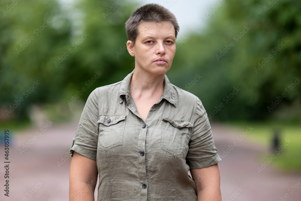 Woman in military uniform walking in park Woman in military uniform walking in park