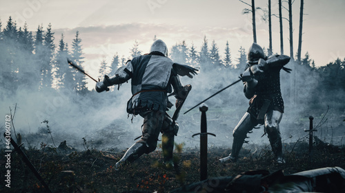 Photographie Epic Battlefield: Two Armored Medieval Knights Fighting with Swords
