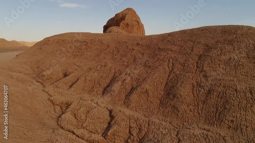 dolly shot from the formation of sandstones in dasht e lut desert at the morning, aerial close up shot the formation of kalut in shahdad desert, iran photo