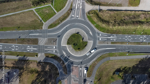 Top down aerial drone view of a small traffic roundabout
