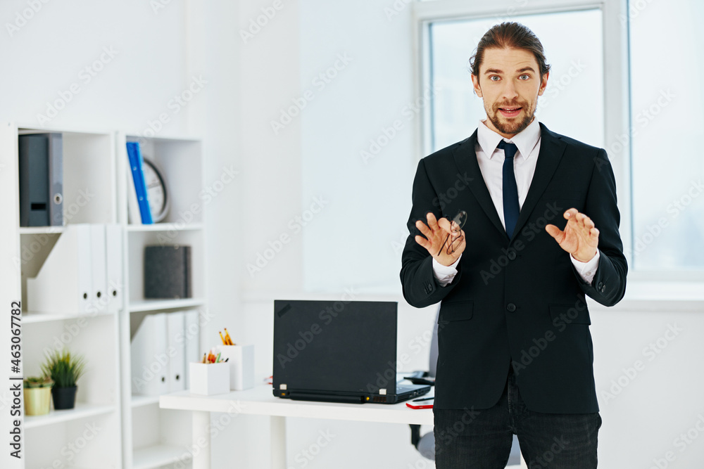man in a suit in the office with documents executive man in a suit in the office with documents executive