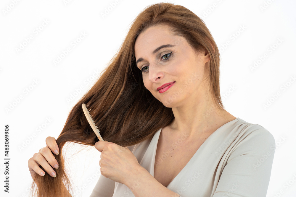 woman combing long brown healthy hair, natural skin woman combing long brown healthy hair, natural skin