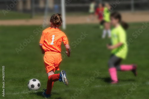 Young girl on Soccer Field running. Granddaughter in youth sports in Kirkwood in Upstate NY in Broome County. Autumn Soccer Game in sunny skies. Athletes at a young age. Girl in ponytail.
