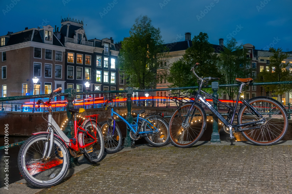 Bicycles on the Canal Embankment in Amsterdam at Night