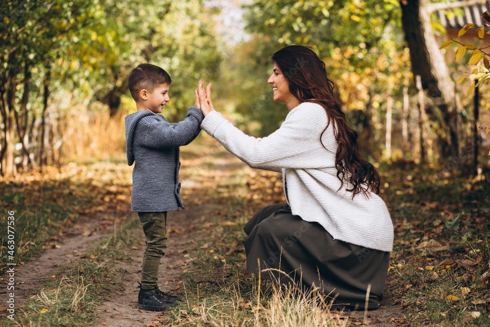 Mother with little son in an autumn park Mother with little son in an autumn park
