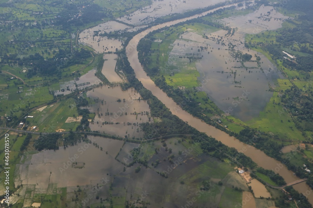 Aerial view of flood area in northeastern of thailand, view from airplane window in the morning. Soft focus. Nature and transportation concept. Aerial view of flood area in northeastern of thailand, view from airplane window in the morning. Soft focus. Nature and transportation concept.