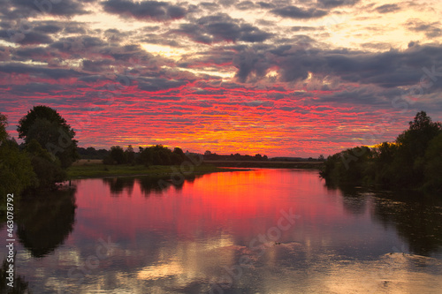 beautiful red pink dawn by the river