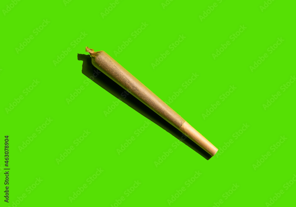 © Mar FernÁndez Navarro/Wirestock - Therapeutic medical cannabis joint isolated on a green background