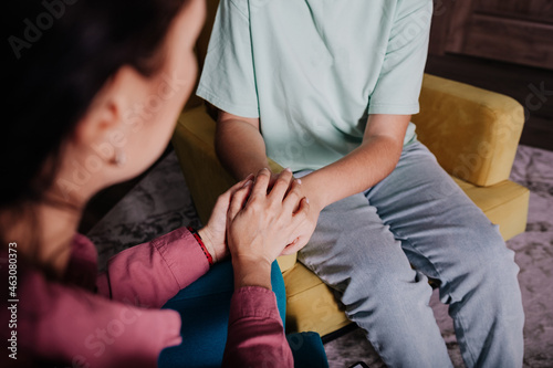 close-up of a female psychologist embracing the patient's hands in a gesture of support