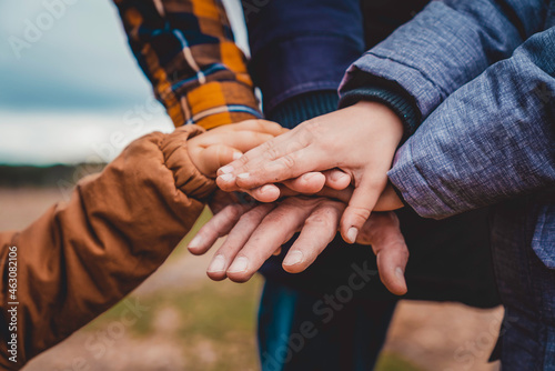 Close-up of the hands of a united family.