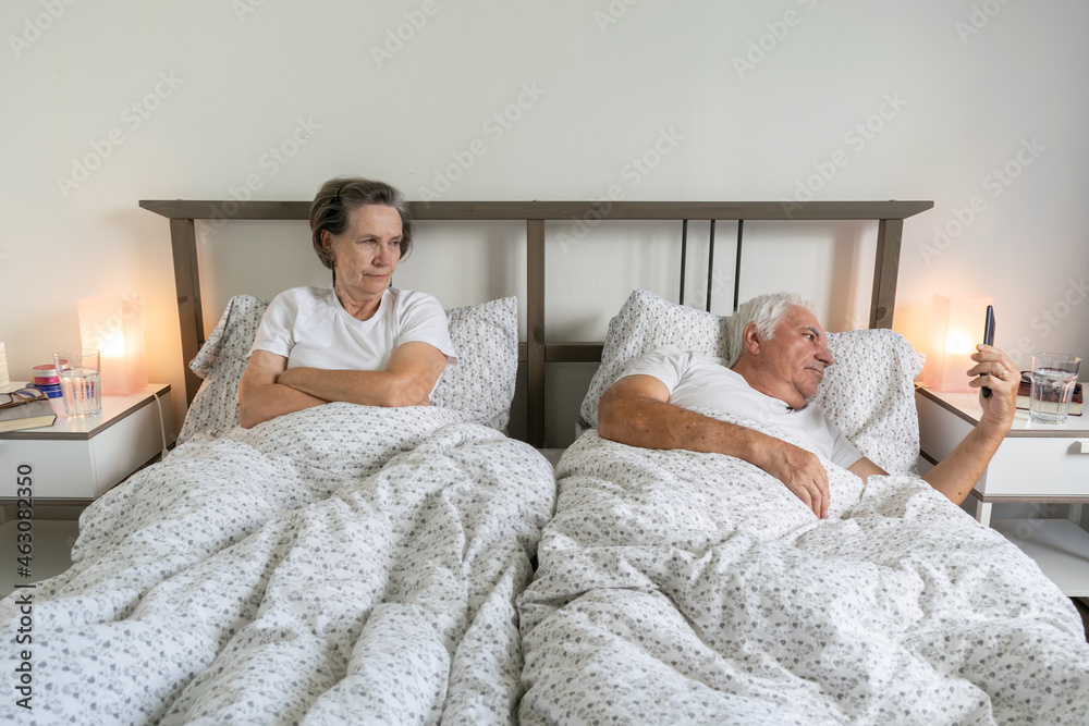 senior aging married couple man male and female woman sleep together in bed sexual problems dysfunction mad angry senior aging married couple man male and female woman sleep together in bed sexual problems dysfunction mad angry